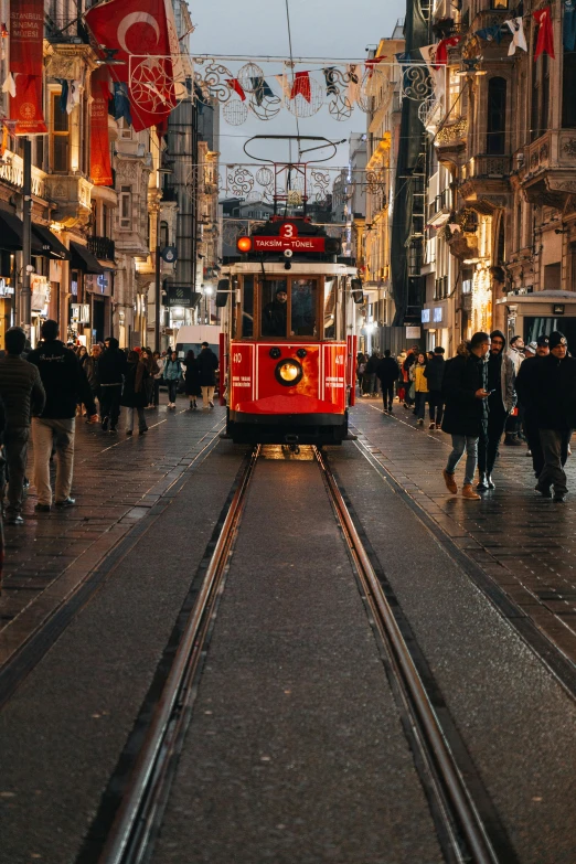 a trolley is going down a busy street