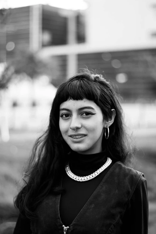 a woman with long black hair and a necklace