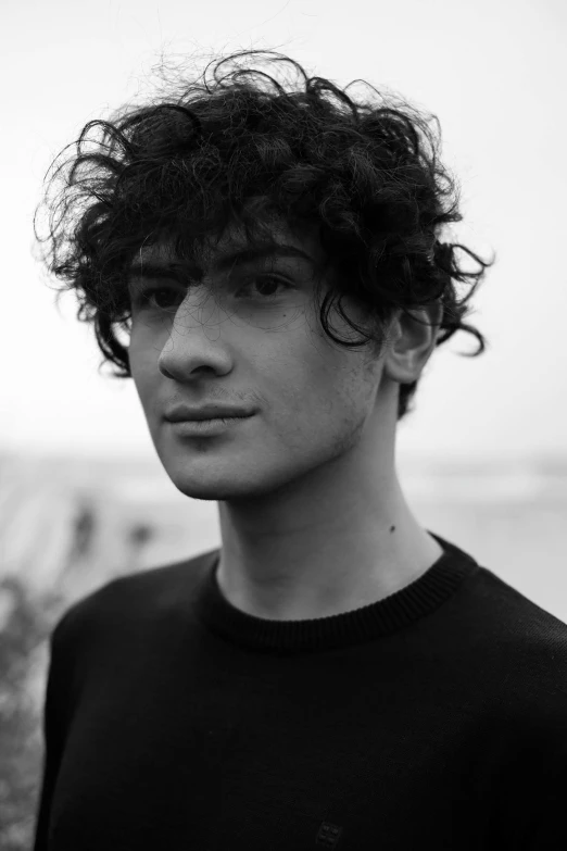 a black and white po of a boy with curly hair