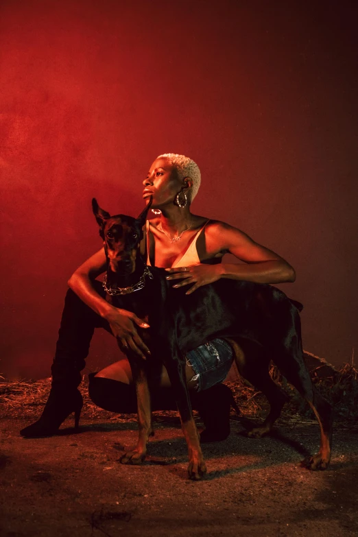 woman and dog posing for pograph in red light