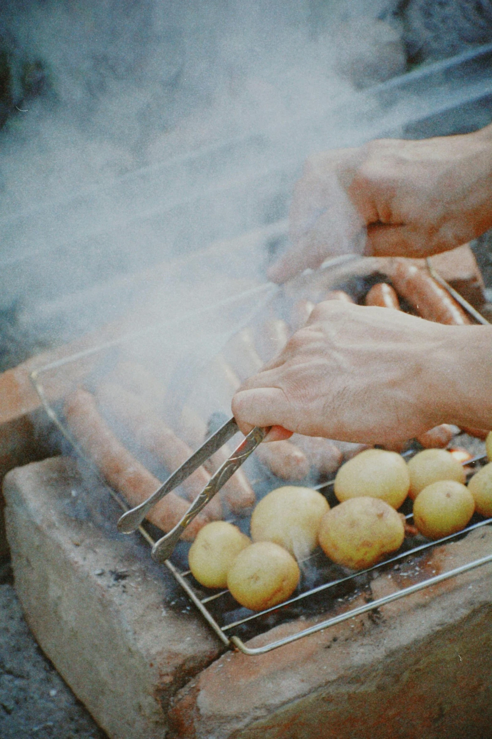 a grill cooking potatoes on a fire