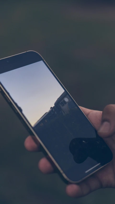 a person holds their cell phone in their hand