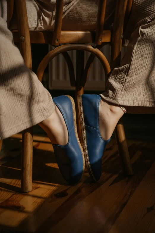 a pair of feet wearing blue loafer shoes