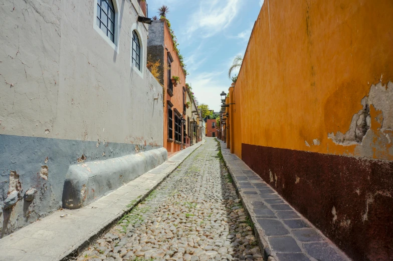 a small old alley lined with stone sidewalks