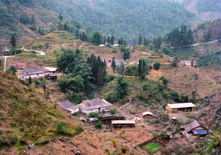 small village in a valley surrounded by trees