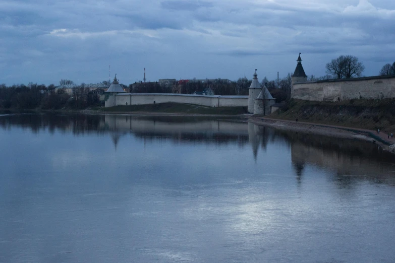 view of a bridge across the water with trees in the background