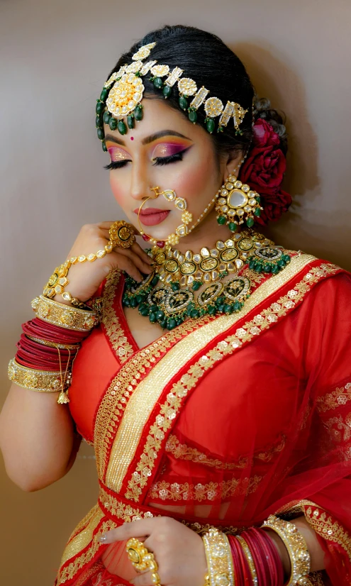 a woman in an indian wedding dress has jewellery set