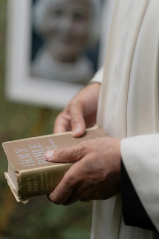 a close up of a person holding a book