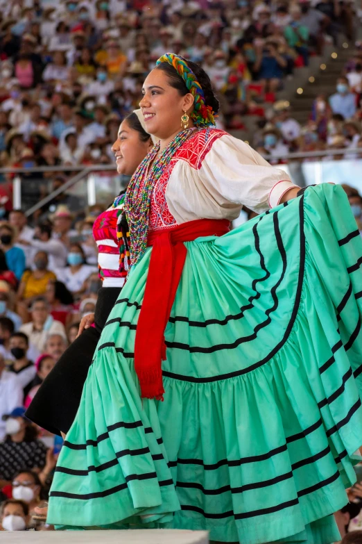 a woman with a colorful dress standing next to a man