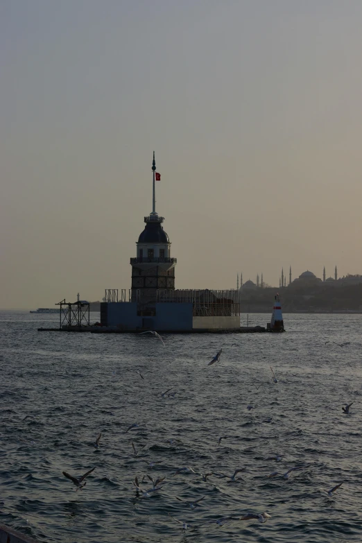 a lighthouse sitting in the middle of a body of water