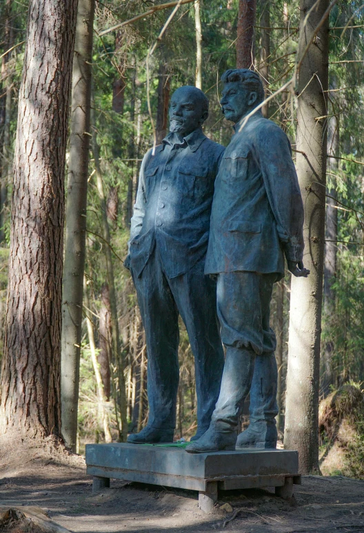 there is a statue in the woods near a man