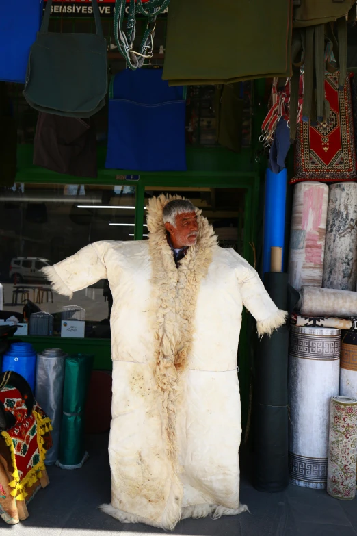 a fur coat is displayed outside on a market stand