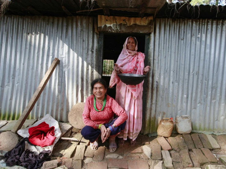 two women standing near a door in a building