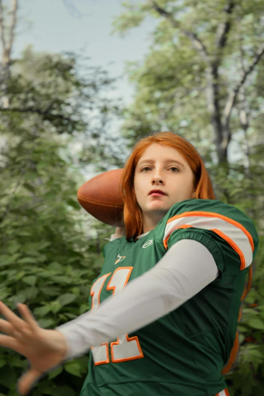 a person with red hair is throwing a football