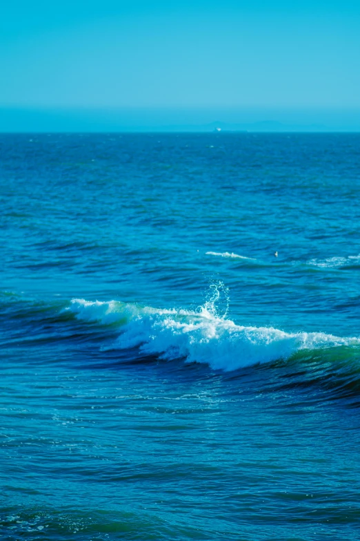 a person is riding their surf board through the water