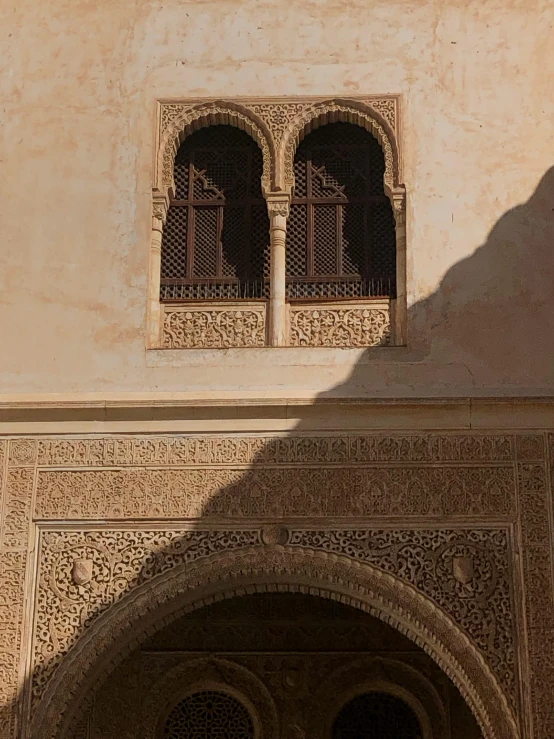 a closeup of an archway in an old building with a clock on it