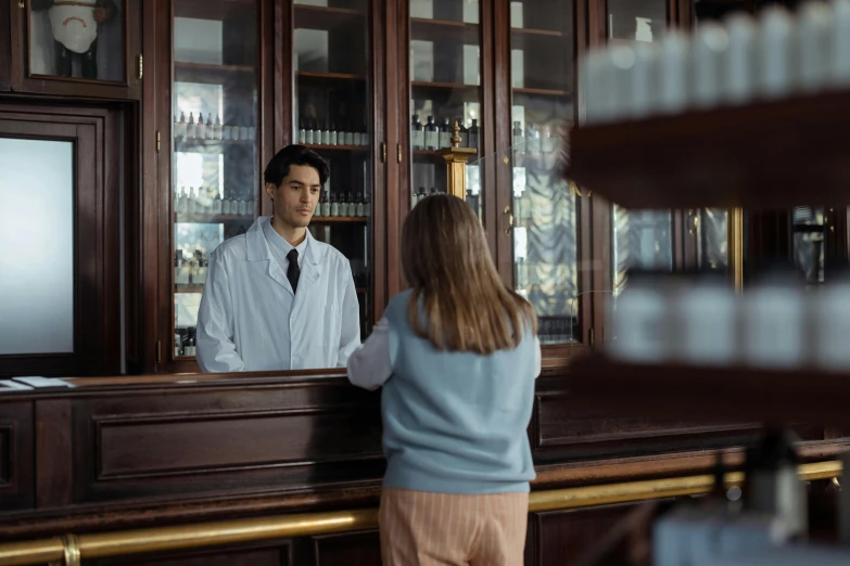 a man standing in front of a wooden bar