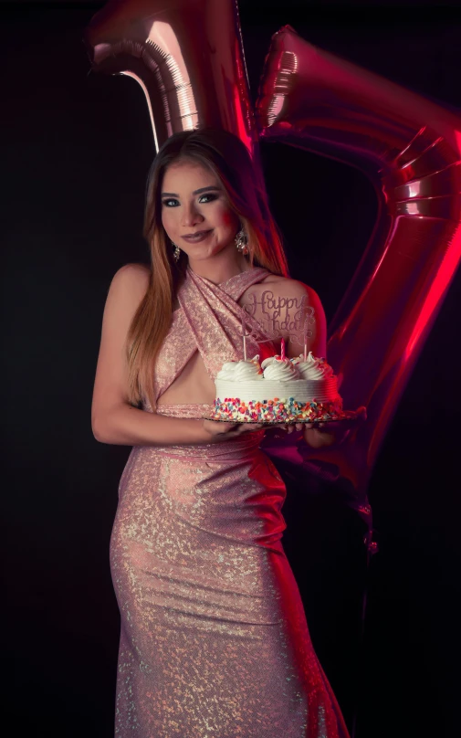 a woman in a gown holding a piece of cake