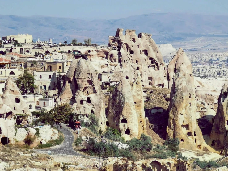 a small village on a hill surrounded by mountains