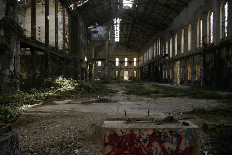an empty warehouse with graffiti on the walls
