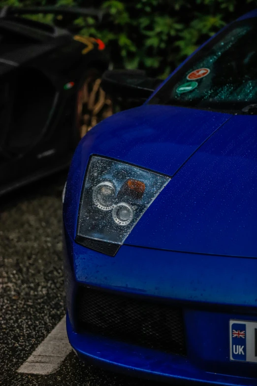 a blue sports car with no ke lights parked in the street