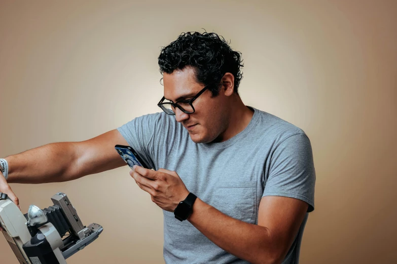 a man using a mobile device to check his watch