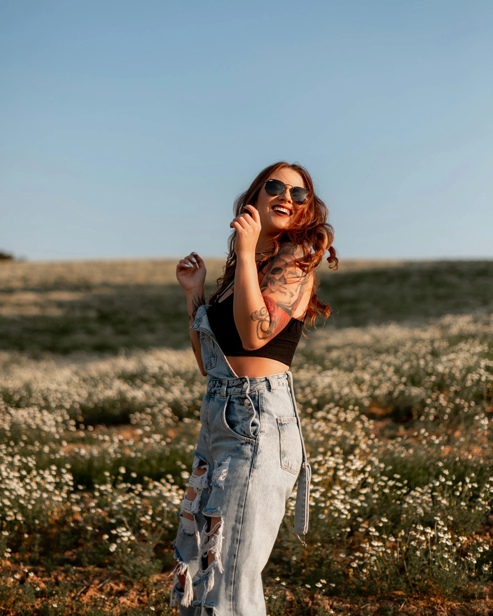 a woman posing in a field of wildflowers