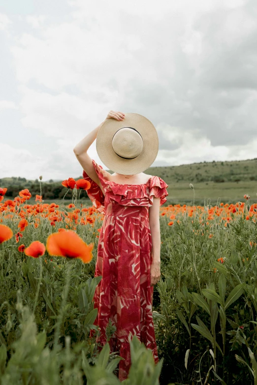 a woman standing in a field of flowers