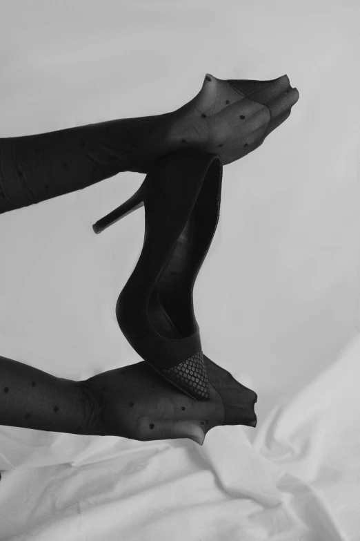 someone is flying above another person's feet in black and white