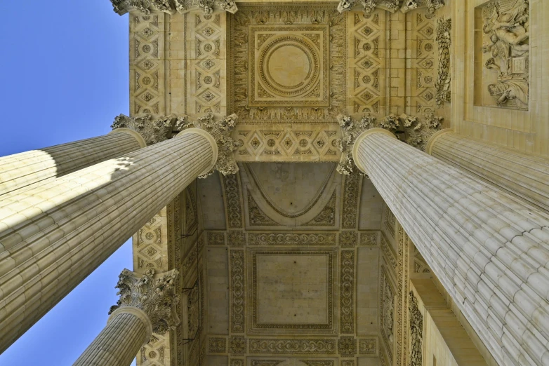 columns with carved patterns and an arch between them