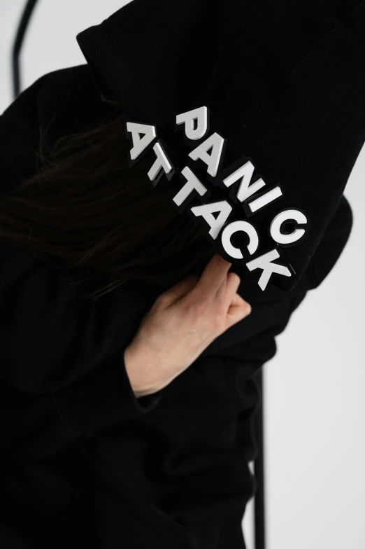 a woman wearing a hoodie with a logo on it