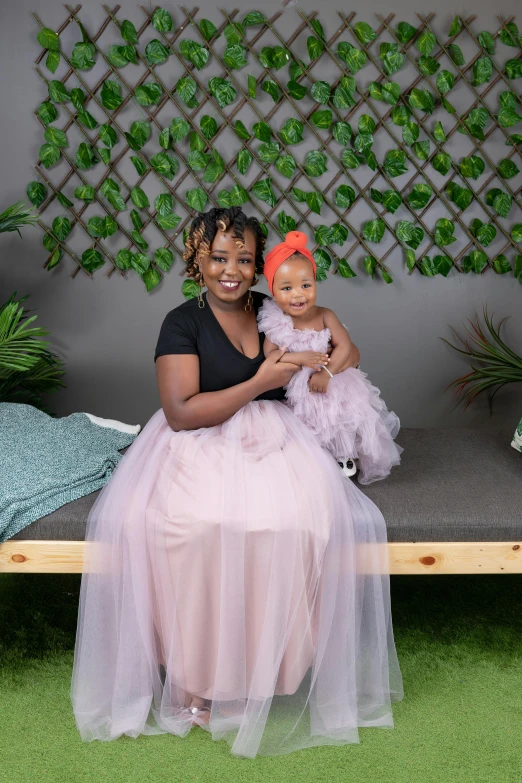 a young black woman holds her doll sitting on a bench