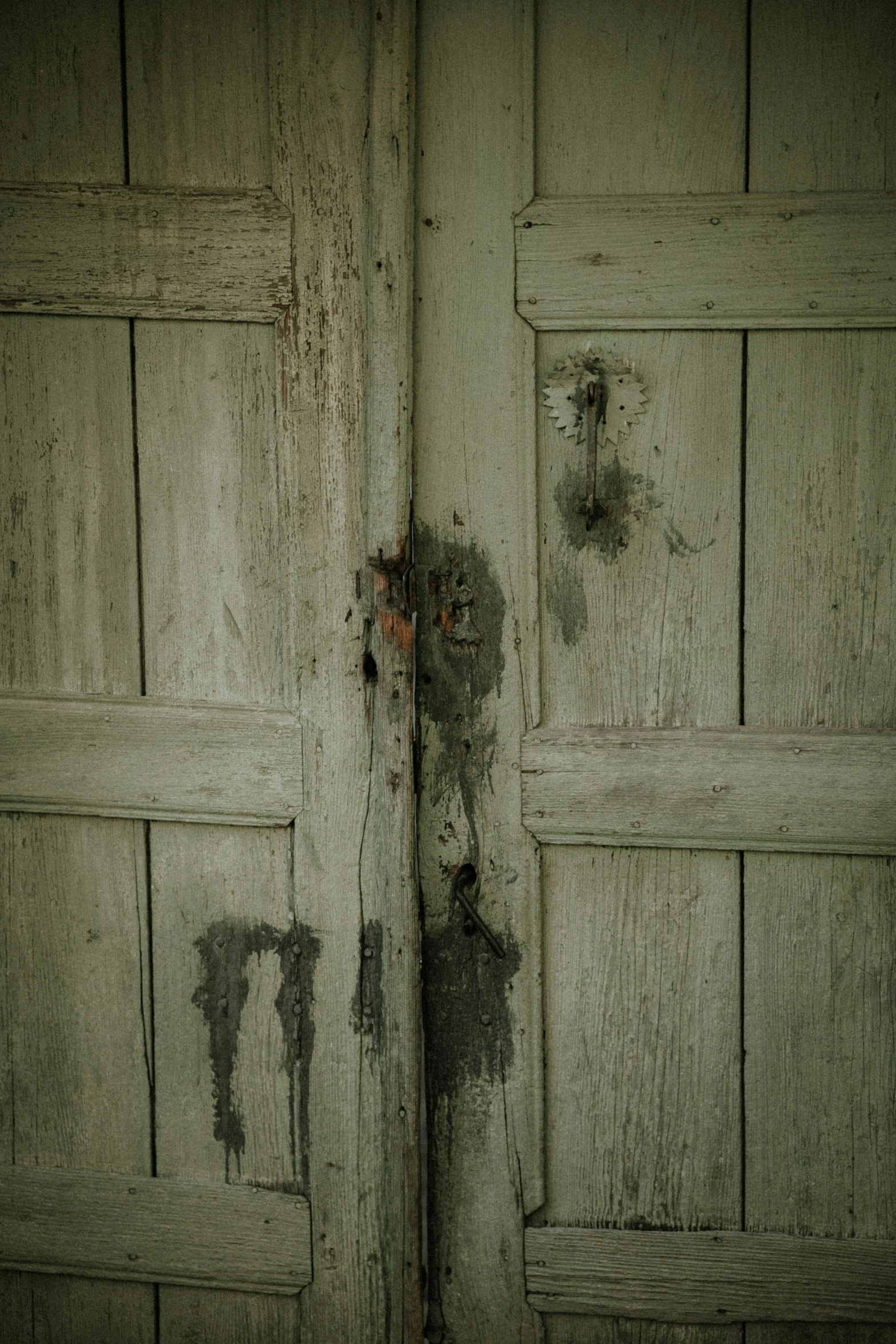the weathered white wood door is still peeling