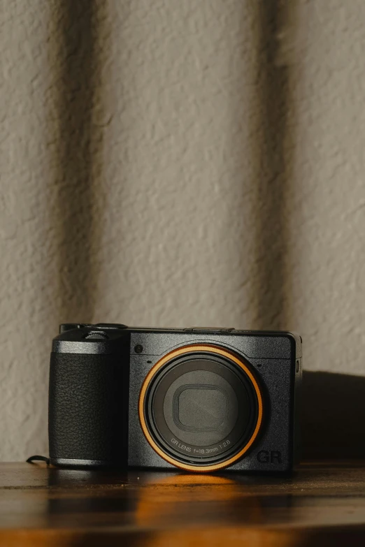 the camera is sitting on the table near a wall