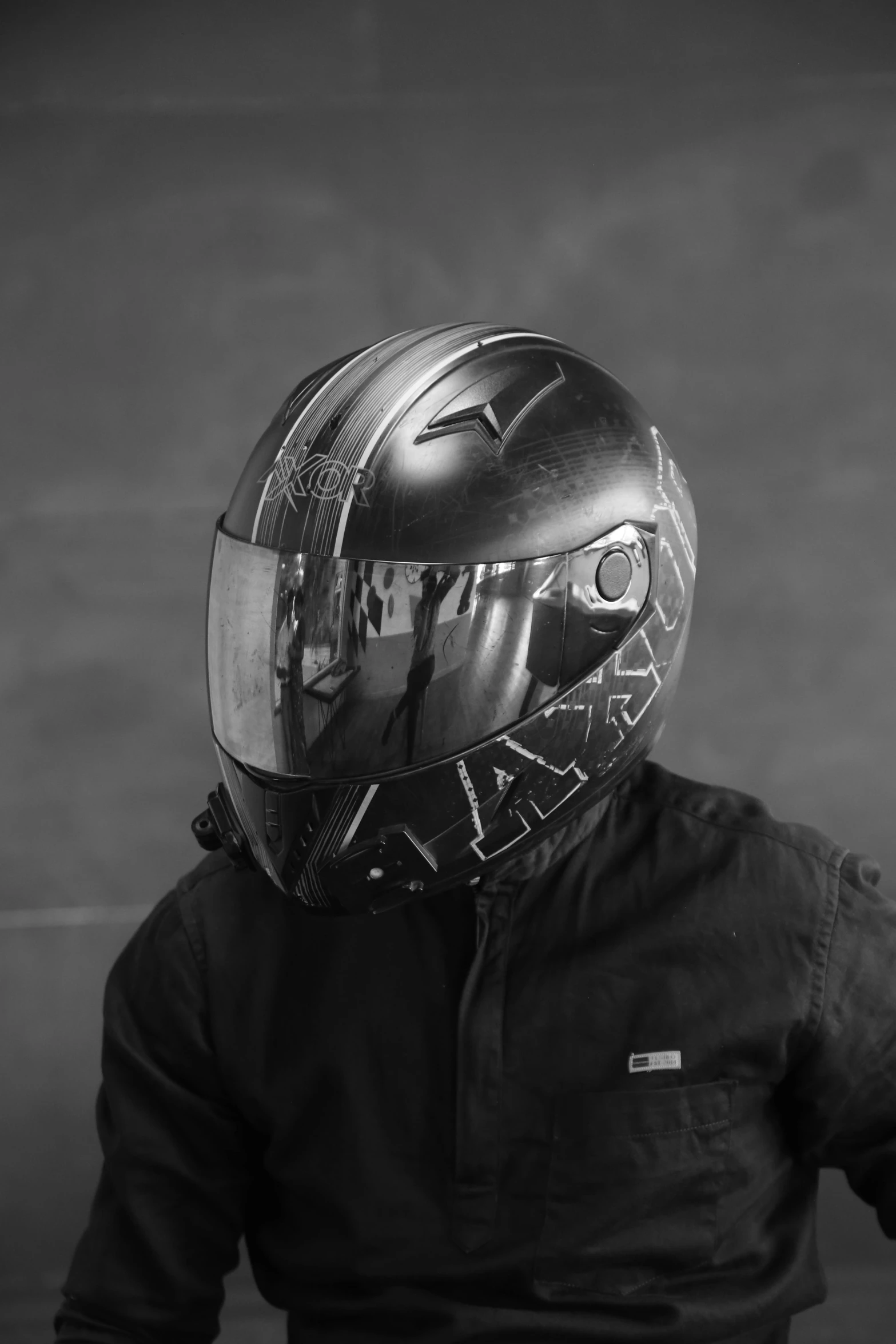 man in helmet and leather jacket standing on stage