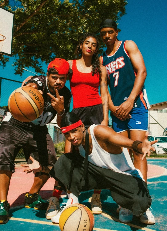 some people in a basketball court posing for the camera