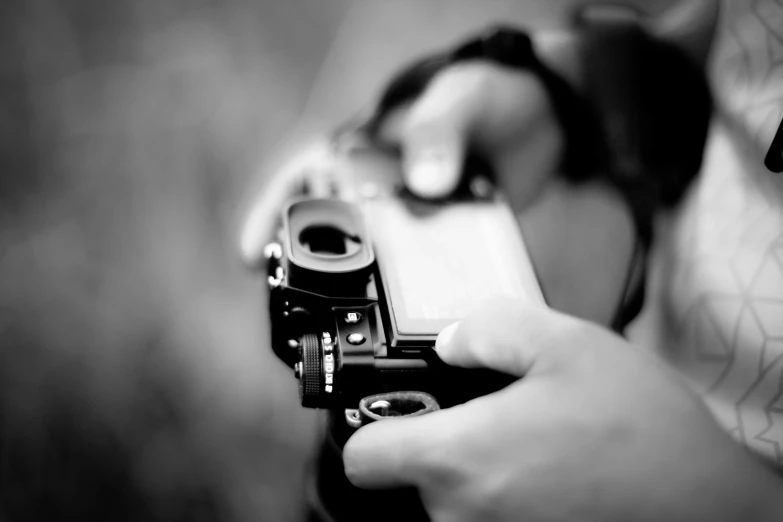 a close up of a person holding a camera