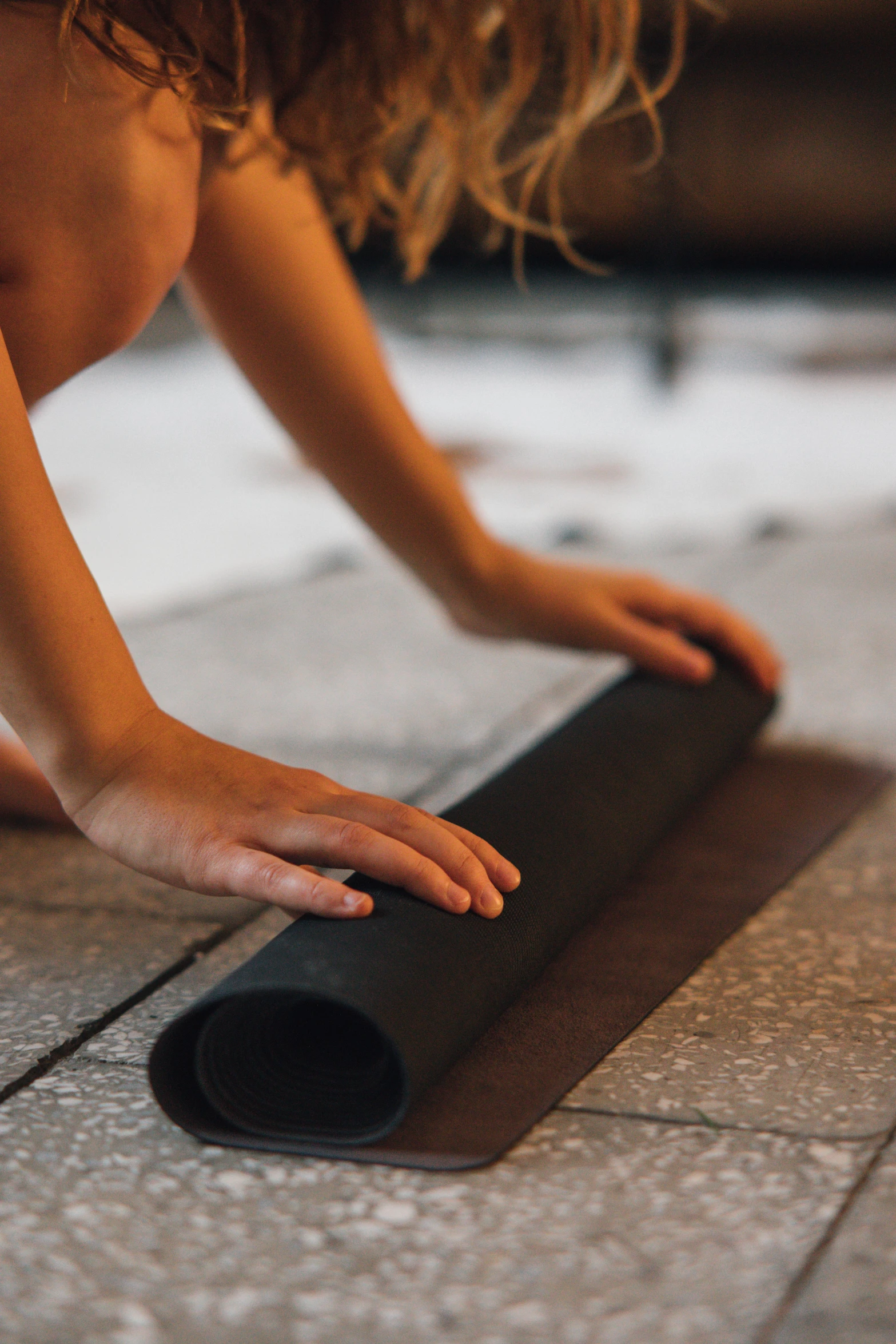 a woman is stretching on the tile by her foot