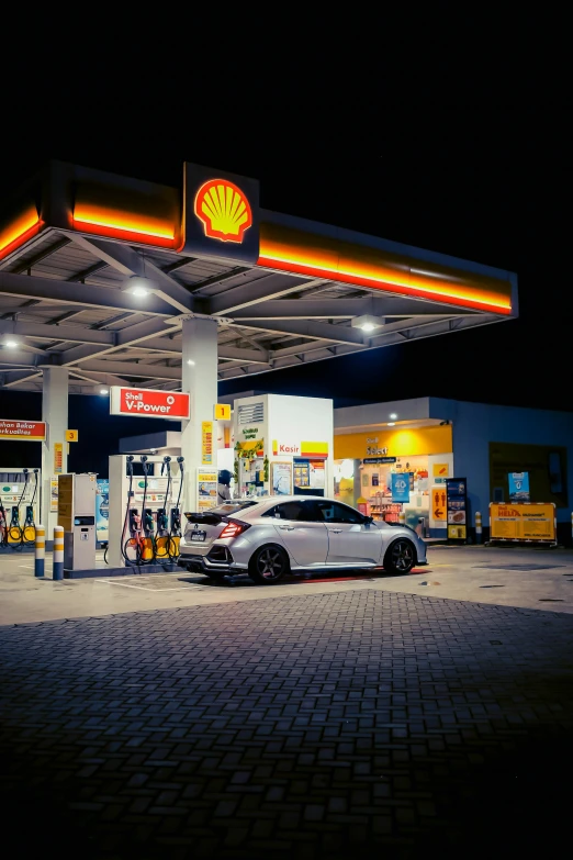 a gas station with a white car in front of it