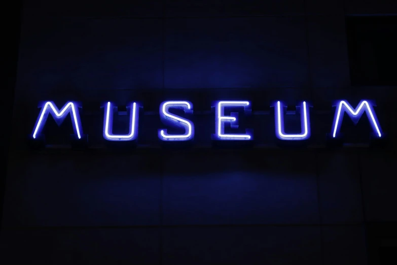 a large illuminated museum sign that reads museum