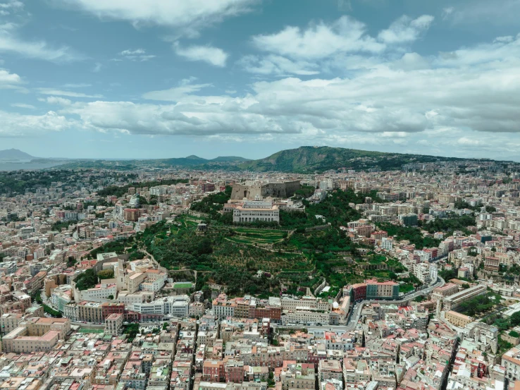 a large city sits in the distance between two hills