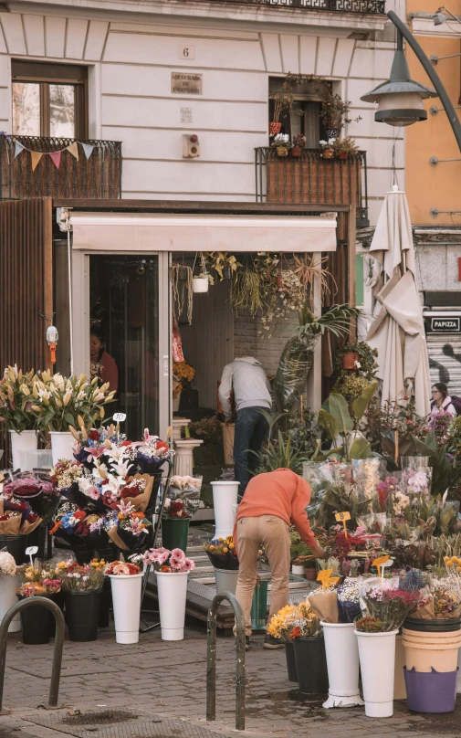 a woman working outside her store in a city