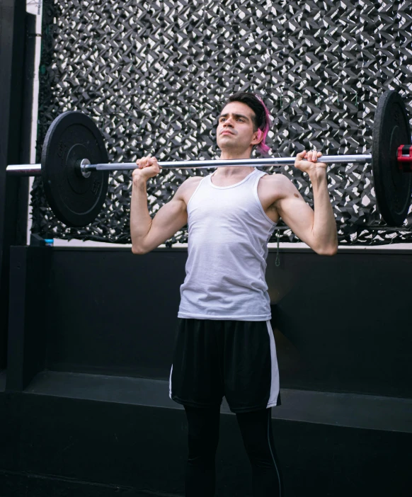 a man with headphones lifting a barbell