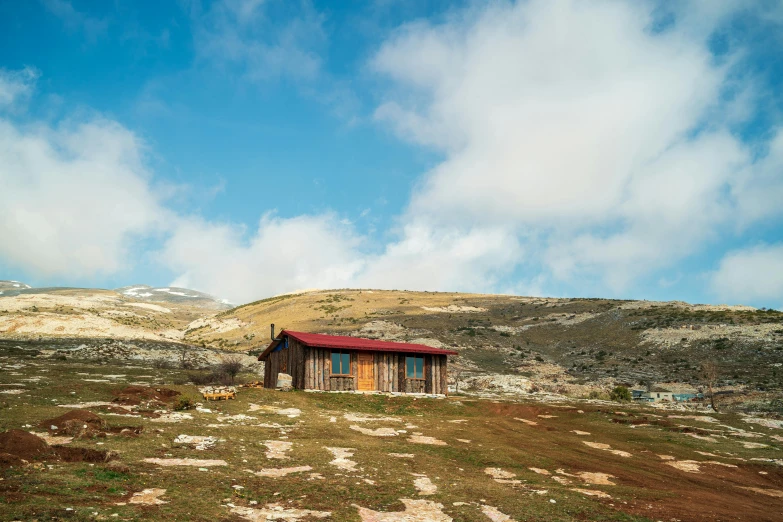 an old building sitting on the side of a hill