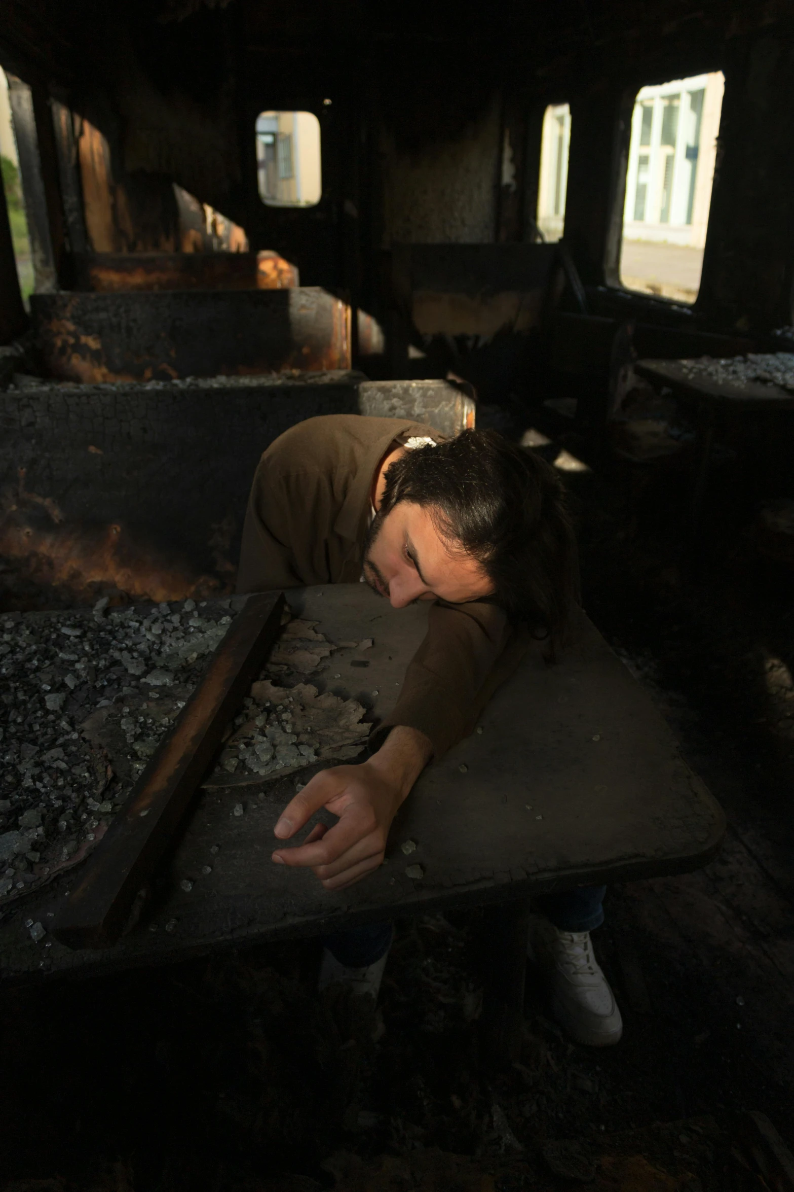 a woman is leaning over the side of the railroad tracks