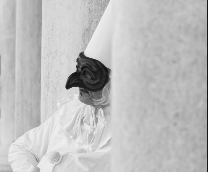 a black bird dressed up as a man in white