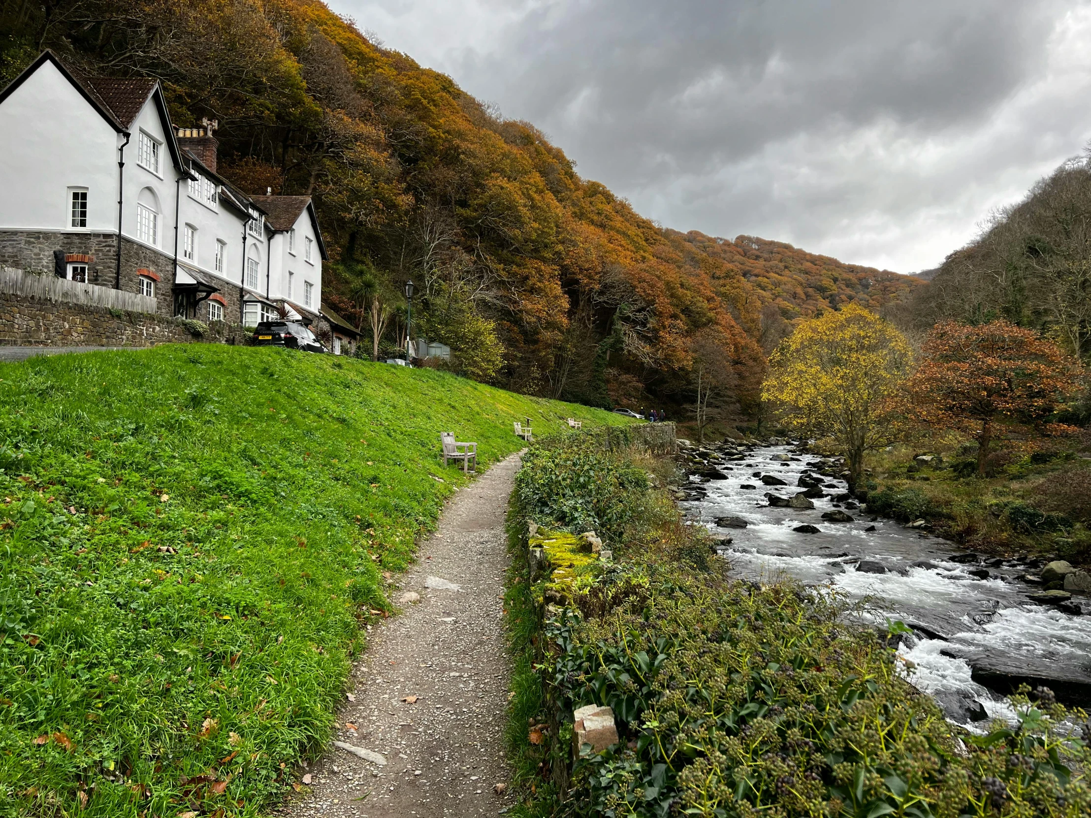 a road near a river next to a white building