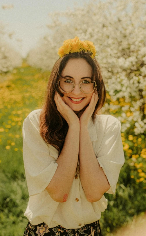a girl wearing glasses and a white shirt with flowers in the background