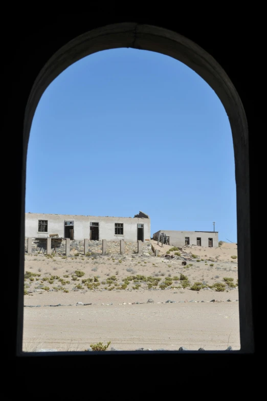 an old house stands in a deserted plain