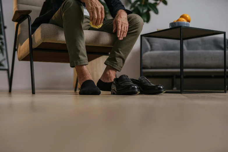 a man is sitting on the couch with his feet up